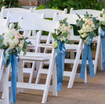 Chairs with floral decorations at a wedding.