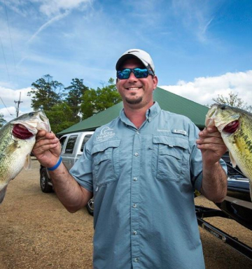 Bass fisherman holding up his catches from a day on Toledo Bend Lake.